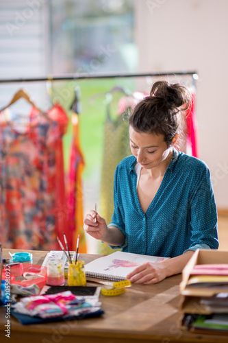 Fashion designer working on a new model, in her studio