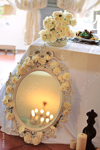 Wedding table decoration with flowers and art elements. Wedding decor. Close up of table appointments. Luxury catering at event photo