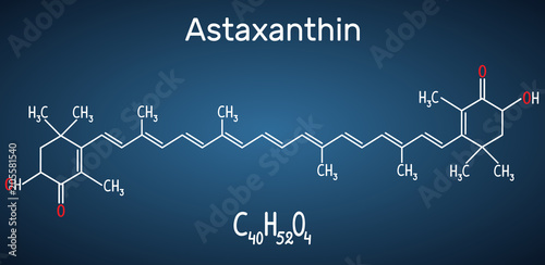 Astaxanthin is a keto-carotenoid. It belongs to class of chemical terpenes Structural chemical formula and molecule model on the dark blue background