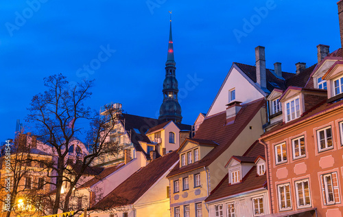 Traditional Latvian houses and spear of Saint Peter church in the center of the old town in Riga, Latvia.