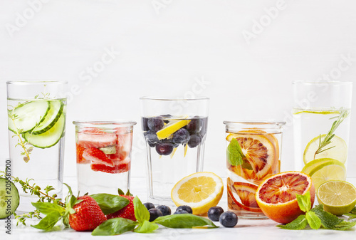 Variety of herbs and fruits flavored infused water and their ingridients. Summer refreshing drink. Health care, fitness, healthy nutrition diet concept.