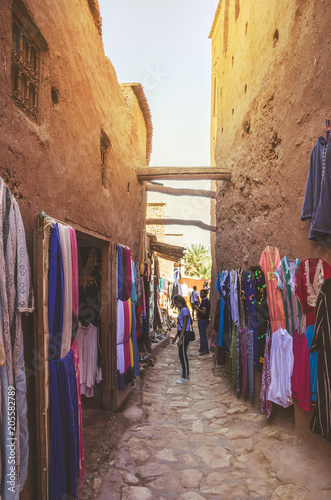 Narrow streets of Kasbah Ait Ben Haddou with traditional moroccan souvenirs, Morocco © Olena Zn
