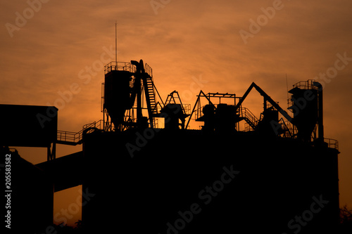 silhouette of cranes at sunset
