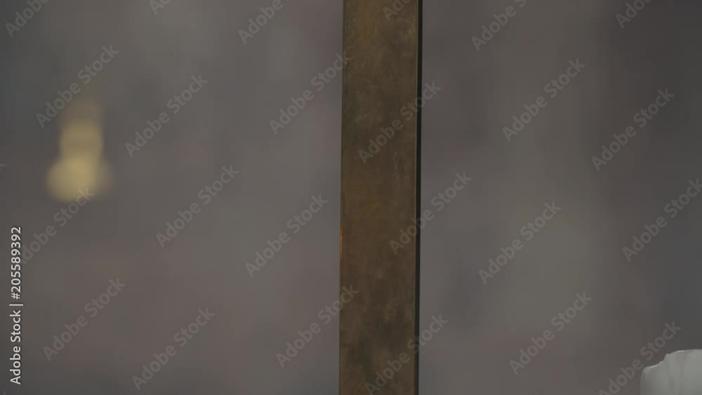 Tilt up on gold cross with haze & stain glass Tilt up on gold cross with haze & stain glass