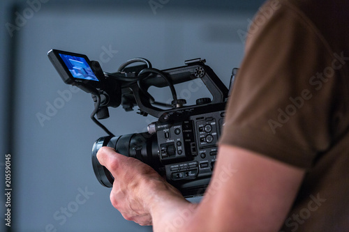 camera operator working with a cinema camera photo