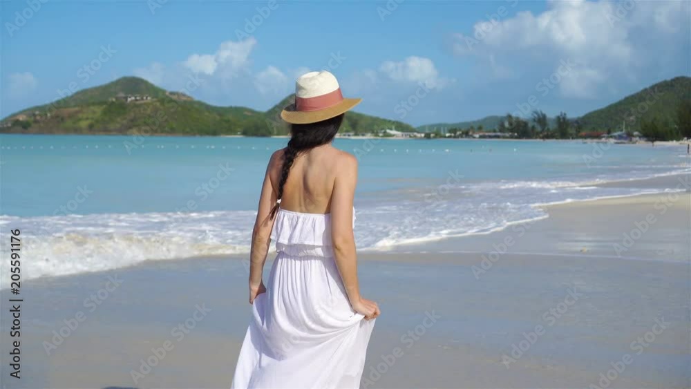 Young beautiful woman on white sand tropical beach. Young beautiful woman on white sand tropical beach.