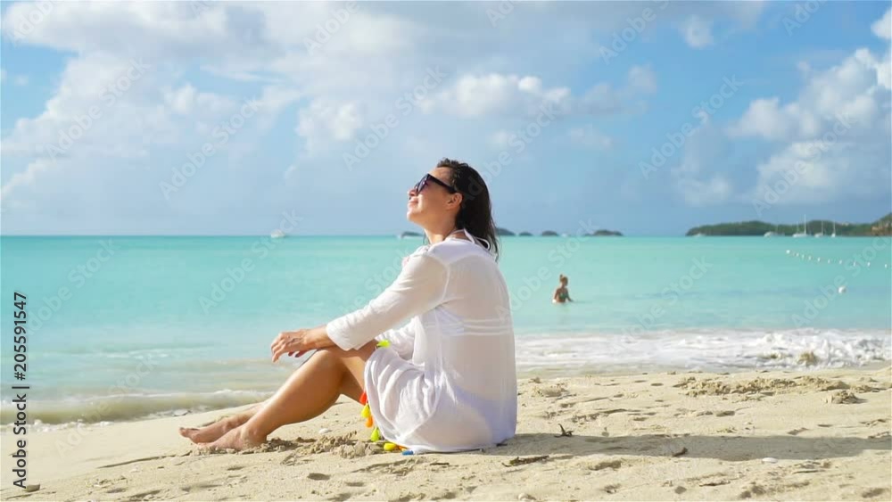 Young beautiful woman on white sand tropical beach. Young beautiful woman on white sand tropical beach.