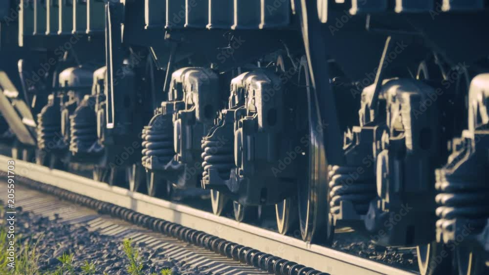 Low angle shot of the wheels of a moving freight train