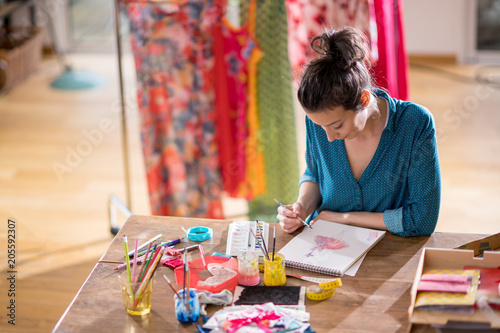 Fashion designer working on a new model, in her studio