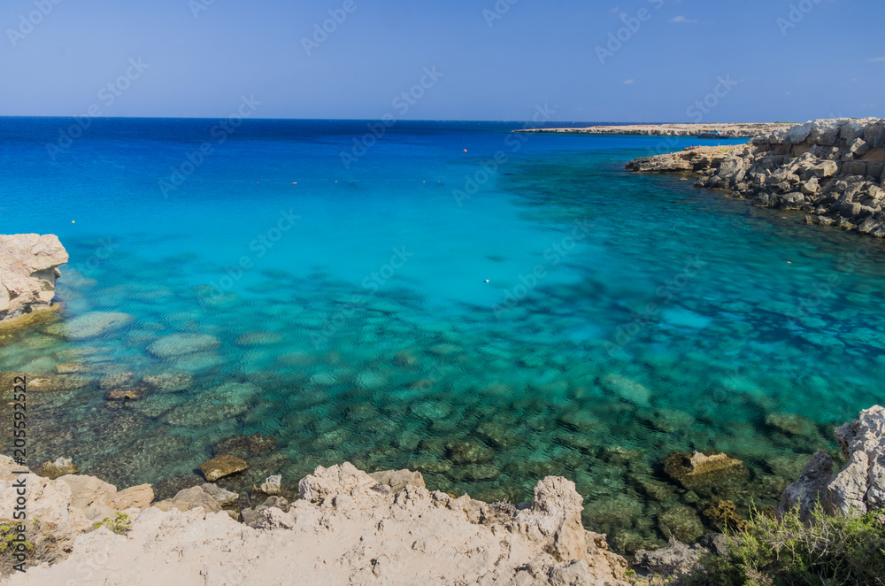 Cape Grecco beautiful crystal clear beach with a tourist cruis approaching, Ayia Napa,Cyprus