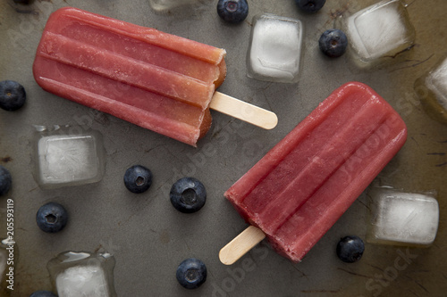 Frozen Homeamde Blueberry Popsicles on a Baking Tray photo