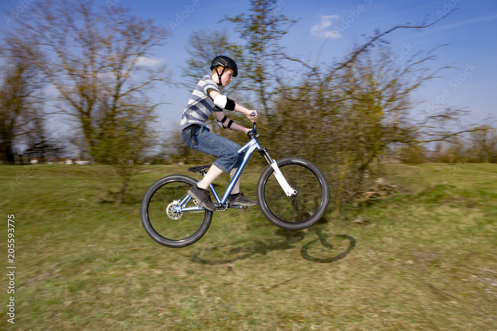 boy jumping with his dirt bike