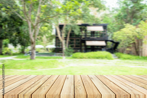 wood table with blur garden and shop background