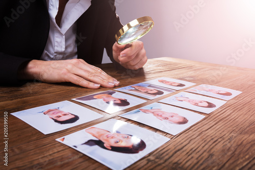 Businessperson Looking At Candidate's Photograph