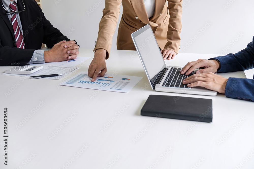 Teamwork process, Business team managers colleagues discussing and analysis new project investment plan, strategy in business profit, marketing documents report on table with laptop and tablet Teamwork process, Business team managers colleagues discussing and analysis new project investment plan, strategy in business profit, marketing documents report on table with laptop and tablet