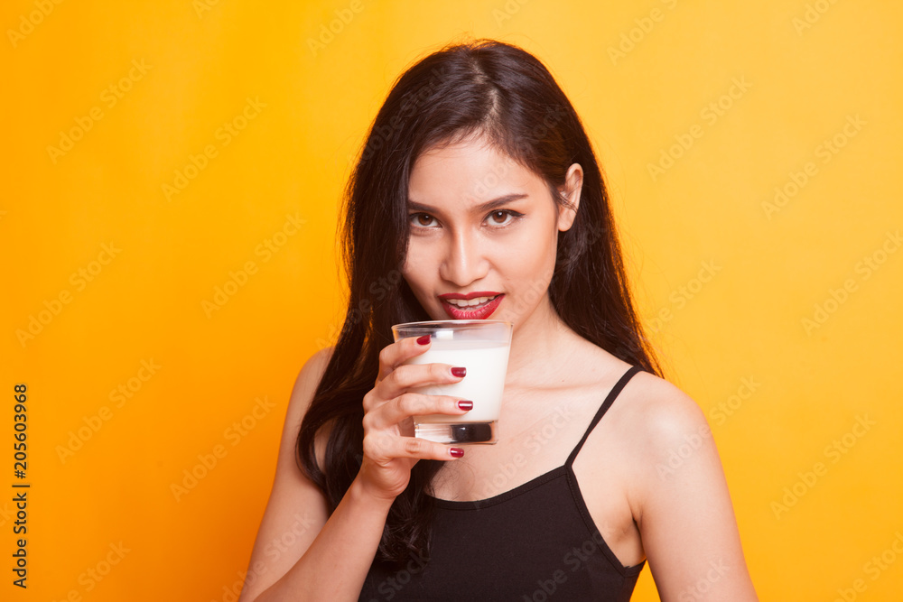 Healthy Asian woman drinking a glass of milk. Healthy Asian woman drinking a glass of milk.