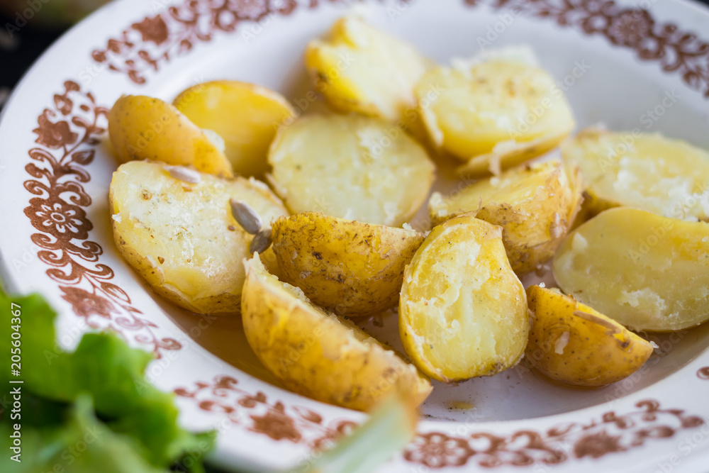 Baked , steamed new potato halves with spices, rock salt and olive or sunflower seeds oil. Raw vegan vegetarian healthy food for lunch or dinner. Organic farm product Baked , steamed new potato halves with spices, rock salt and olive or sunflower seeds oil. Raw vegan vegetarian healthy food for lunch or dinner. Organic farm product