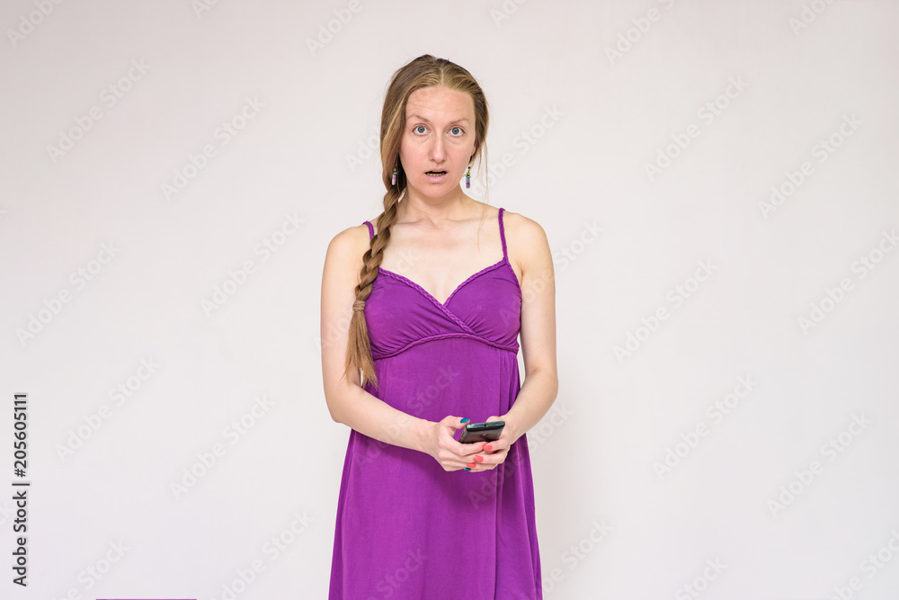 Portrait of a beautiful woman using a smartphone on a white background. Portrait of a beautiful woman using a smartphone on a white background.