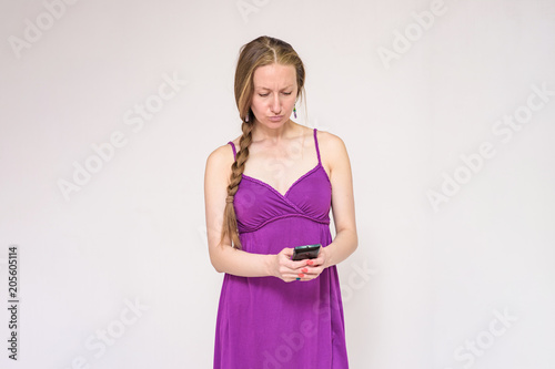 Portrait of a beautiful woman using a smartphone on a white background.