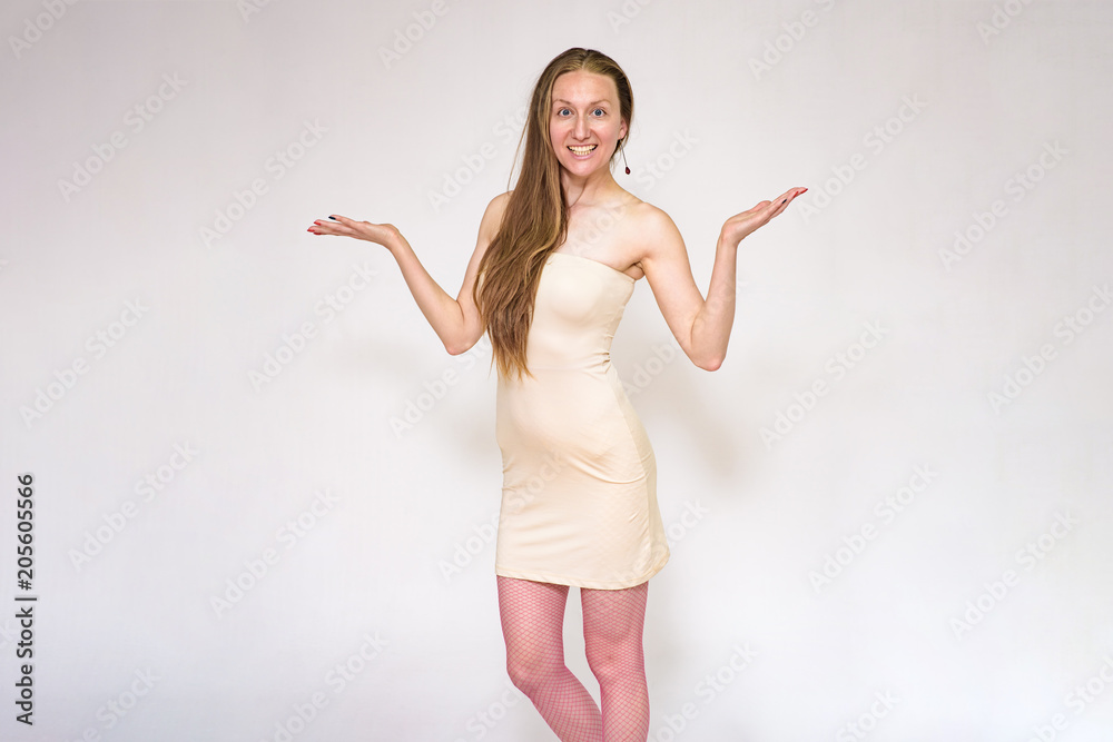 Portrait of a beautiful surprised woman on a white background showing on camera Portrait of a beautiful surprised woman on a white background showing on camera