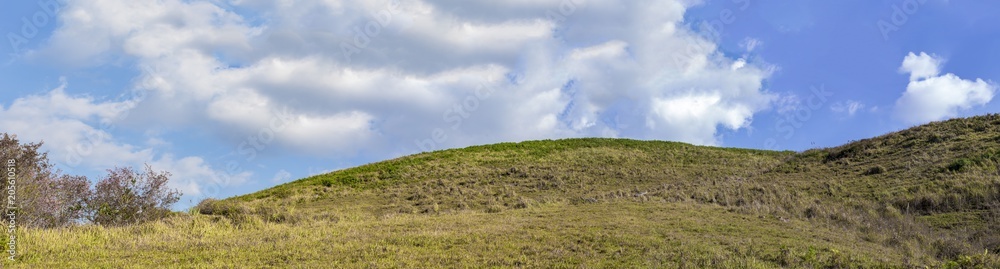 Panorama view of green mountain with blue sky and white cloud