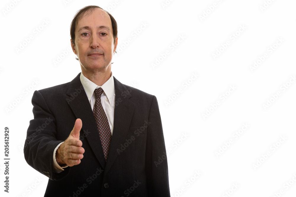 Studio shot of mature businessman giving handshake Studio shot of mature businessman giving handshake