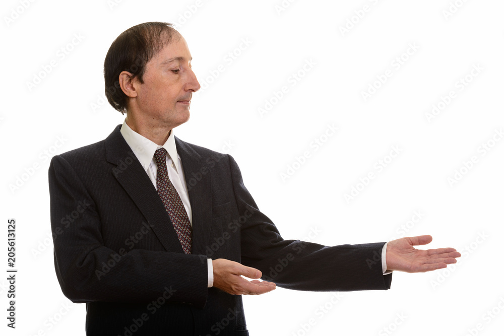 Studio shot of mature businessman showing something
