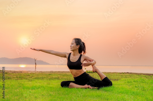 The Yoga woman is relax on the fresh grass as floor.