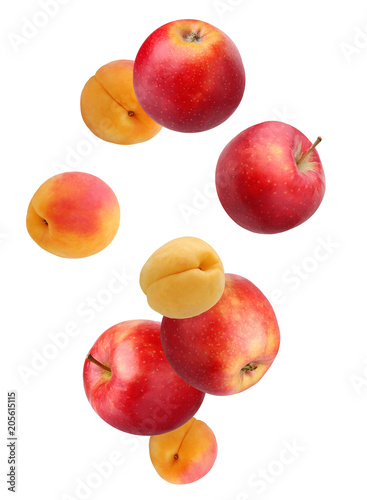 Falling fruit: apples and apricots isolated on white background.