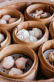 Barbecued pork buns served in steamer baskets with many kind of Dim sum.