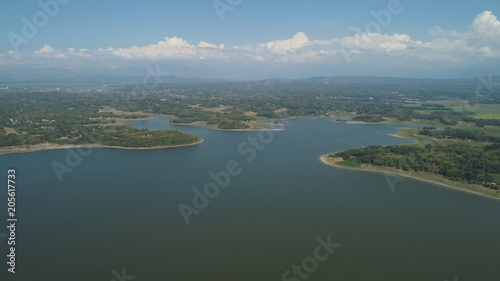 Aerial view of Paoay lake against background of mountains and sky with clouds. Paoay Lake National Park, Ilocos Norte, Philippines.