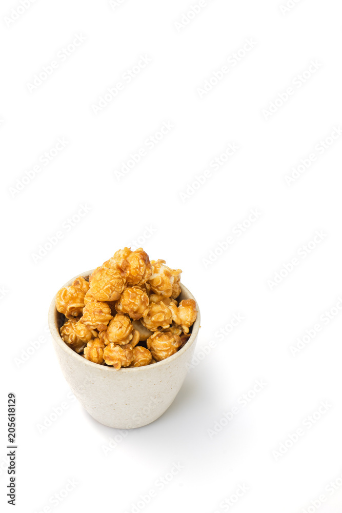 popcorn with caramel in white tiled cup isolated on white background. popcorn with caramel in white tiled cup isolated on white background.