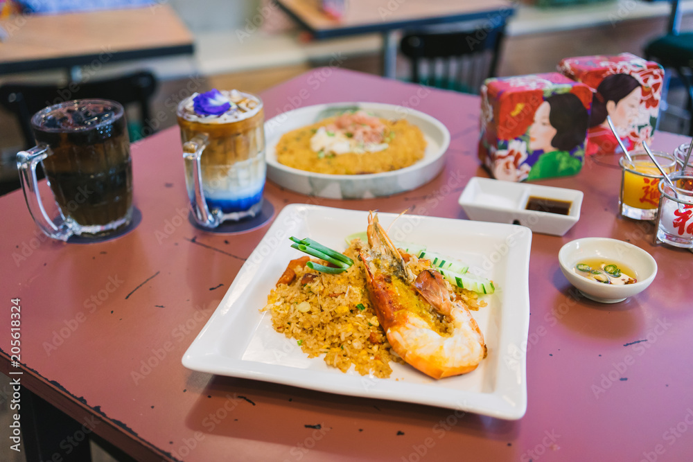 The popular Thai street food is Giant freshwater prawn fried rice on the table in the restaurant. The popular Thai street food is Giant freshwater prawn fried rice on the table in the restaurant.