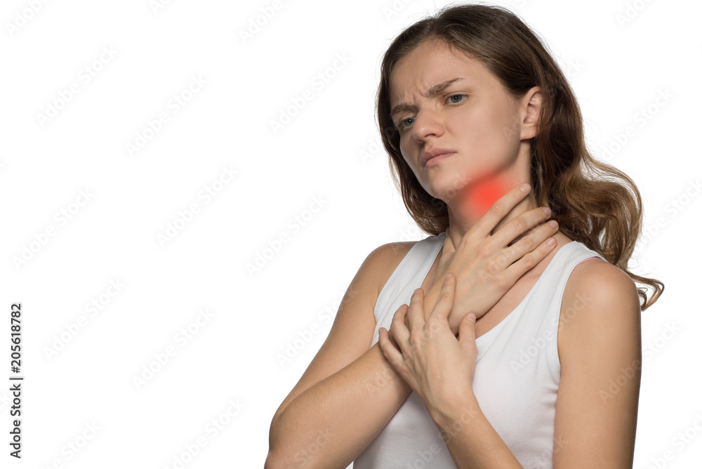 Beautiful woman holding her neck, because she hurts against a white background Beautiful woman holding her neck, because she hurts against a white background