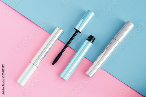 Set of mascara for eyelashes on colorful pink and blue background photo