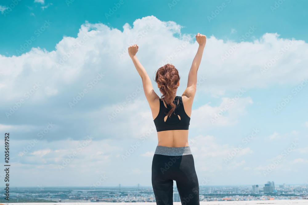 Success and life goals concept. Strong and confident woman with arms in the air. Success and life goals concept. Strong and confident woman with arms in the air.
