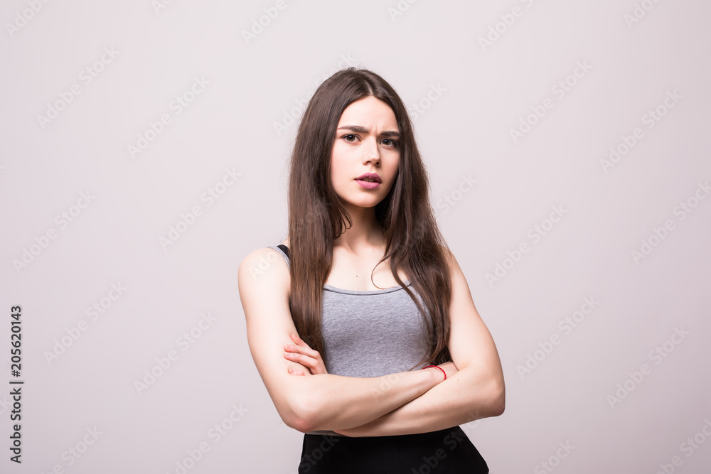 Portrait of beautiful business woman standing with hands folded and looking at camera over white background Portrait of beautiful business woman standing with hands folded and looking at camera over white background
