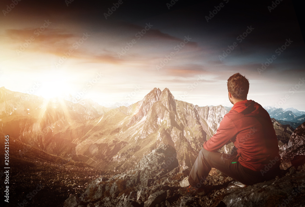 Mountaineer looking over mountain sunrise scene