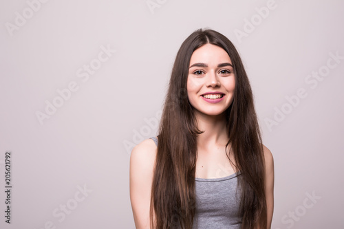 Portrait of adorable attractive woman isolated on gray background