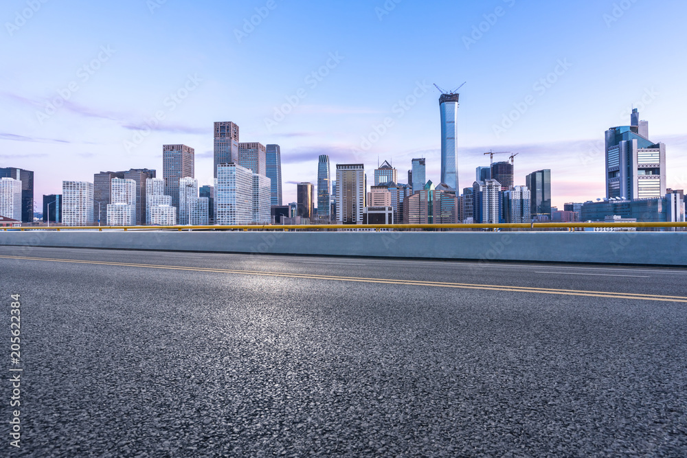 empty road with city skyline empty road with city skyline