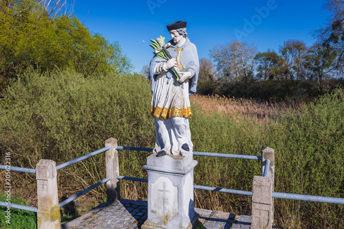 Figure of a saint next to castle in Eckartsau town in Austria photo