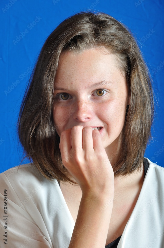 Scared teen on blue background Scared teen on blue background
