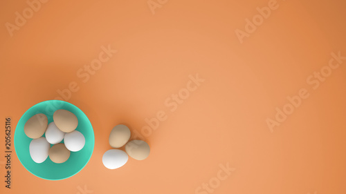 Chicken eggs into a turquoise cup on the table, orange background with copy space, breakfast easter food concept idea, top view