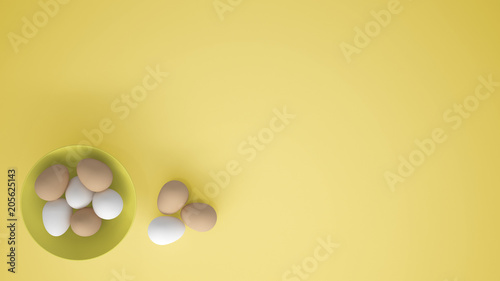 Chicken eggs into a yellow cup on the table, yellow background with copy space, breakfast easter food concept idea, top view