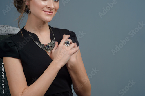 Fashion portrait of young beautiful woman with jewelry and elegant hairstyle.