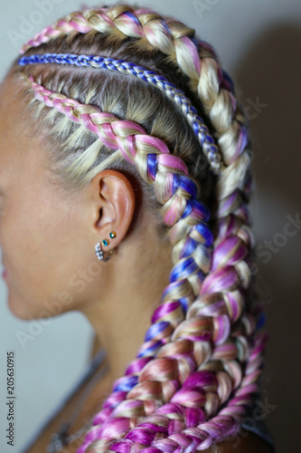 Tablou pe pânză a beautiful hairstyle made of thick and thin braid on the head with a colored ka