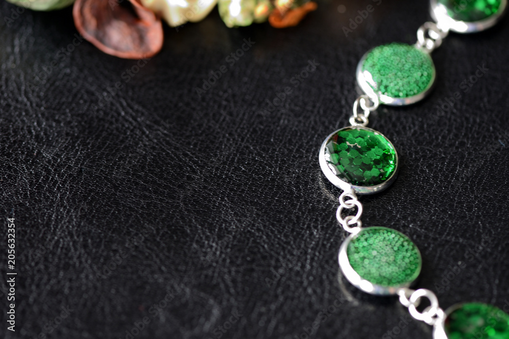 Green resin bracelet on a dark background close up Green resin bracelet on a dark background close up
