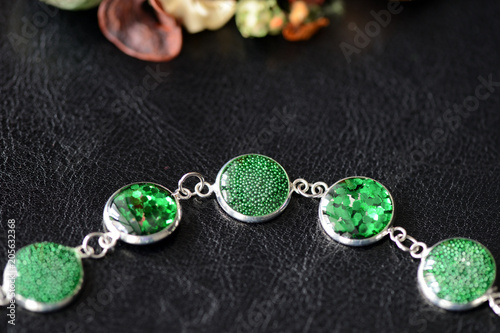 Green resin bracelet on a dark background close up