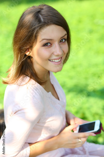 Young woman reading a message on a cell phone