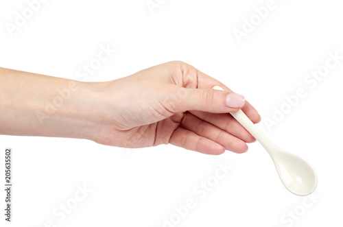 Porcalain brown tea spoon with hand isolated on white background photo